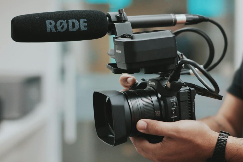 A hand holding a camera for a video production
