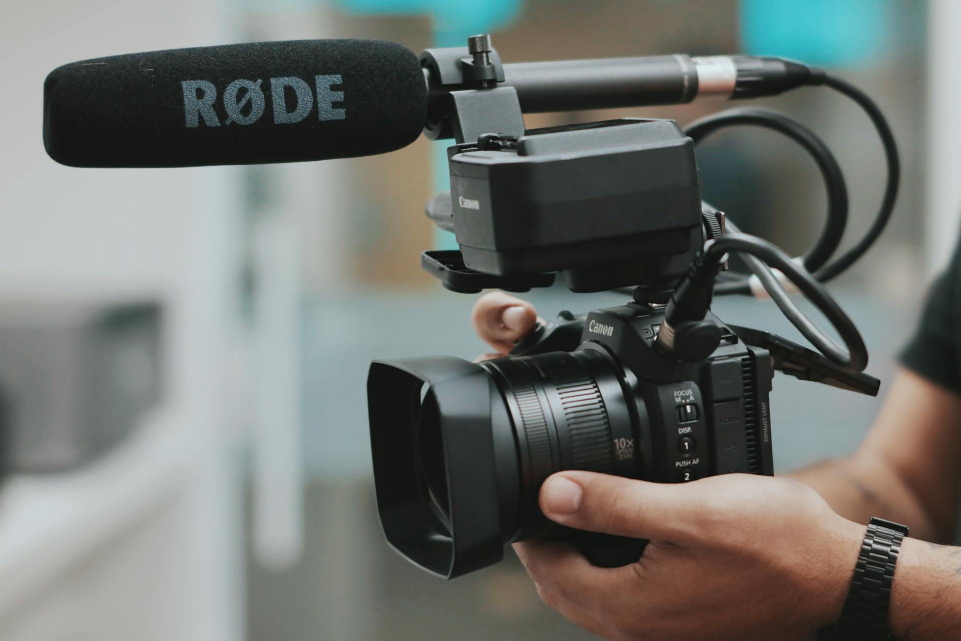 A hand holding a camera for a video production